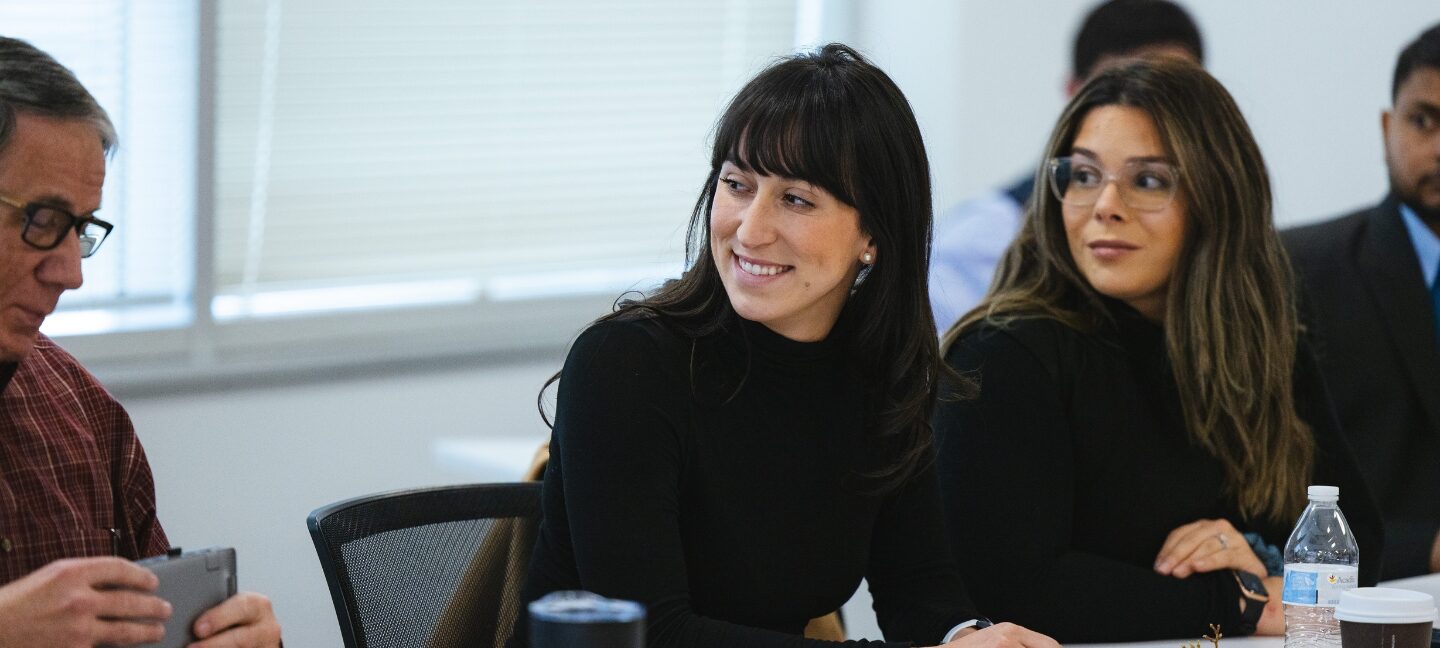 Four members of AcuTech Consulting Group in a meeting. Explore careers opportunities to join the team.